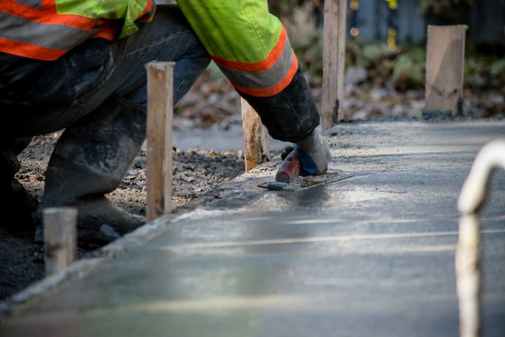 worker smoothing concrete