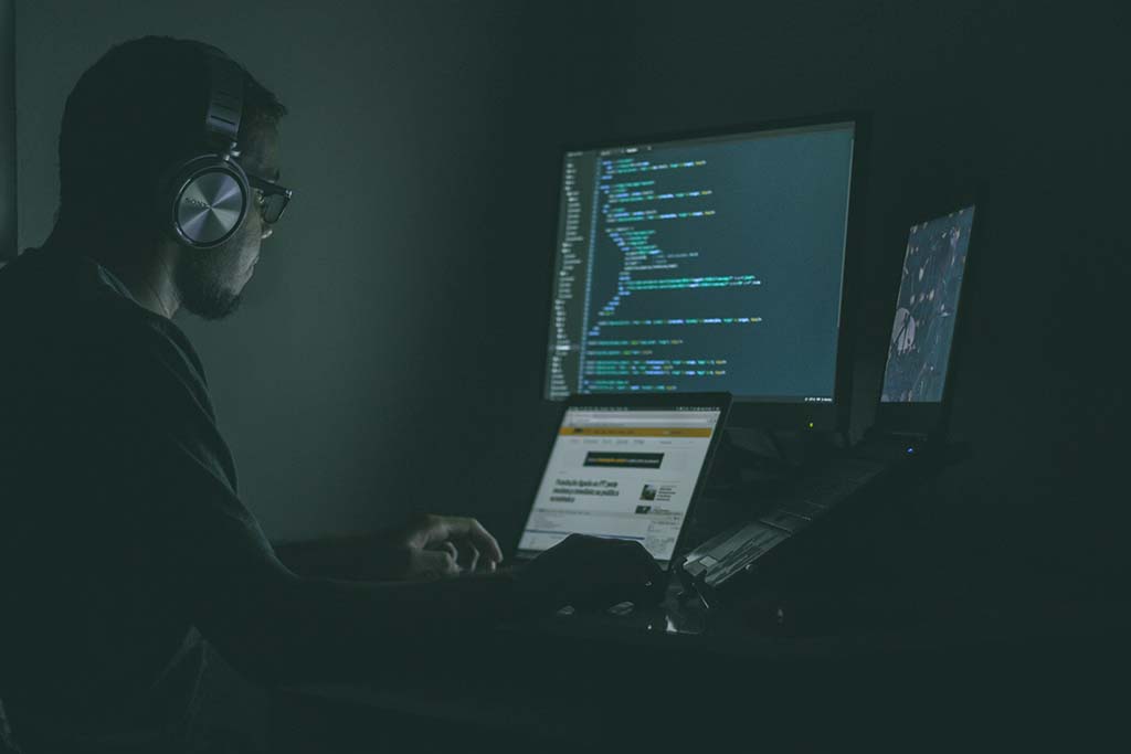 man with headphones looking at data