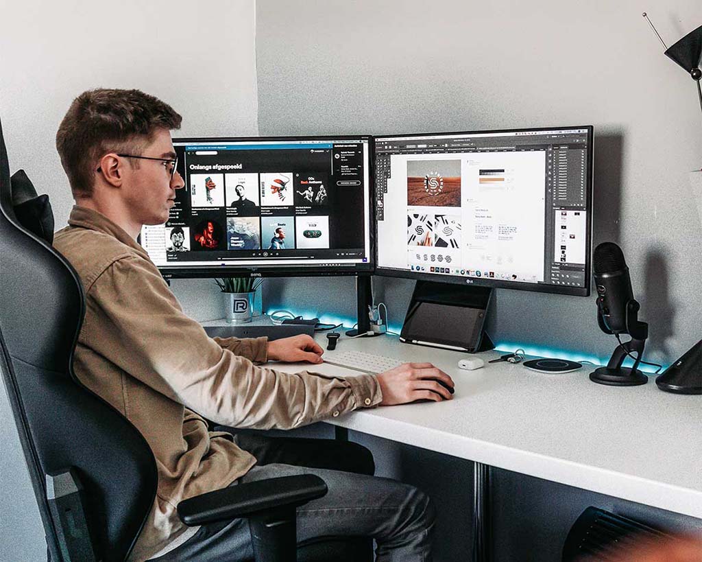 young man with multiple monitors