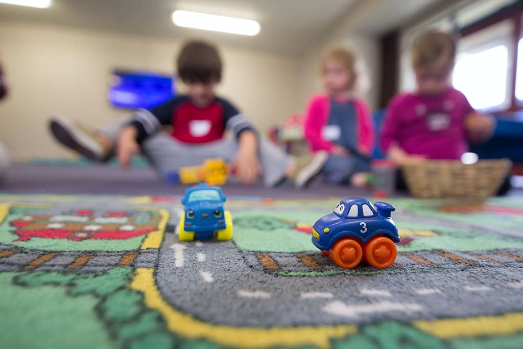 children playing with toy cars