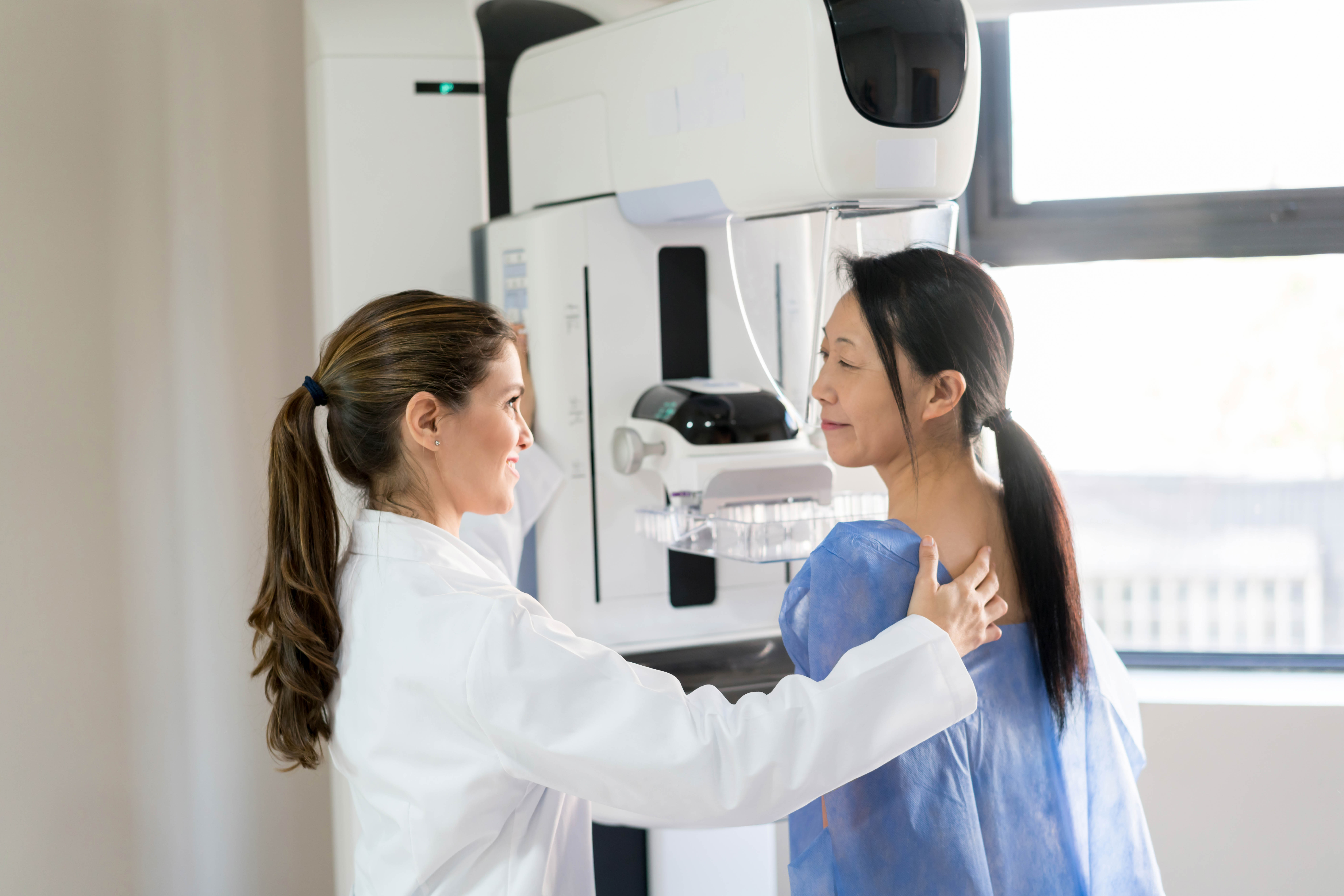 tech and patient in mammogram