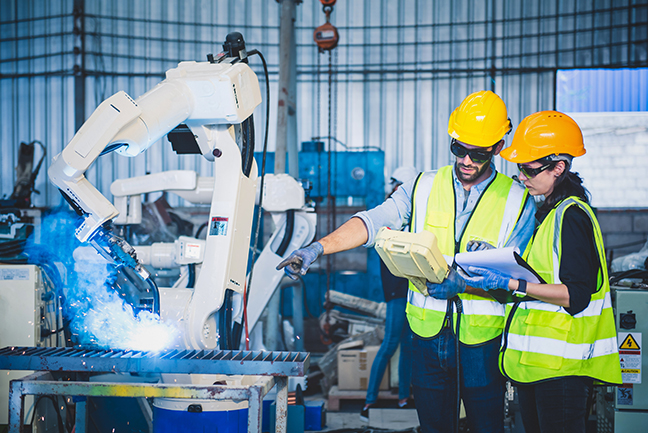 two people working with robotics