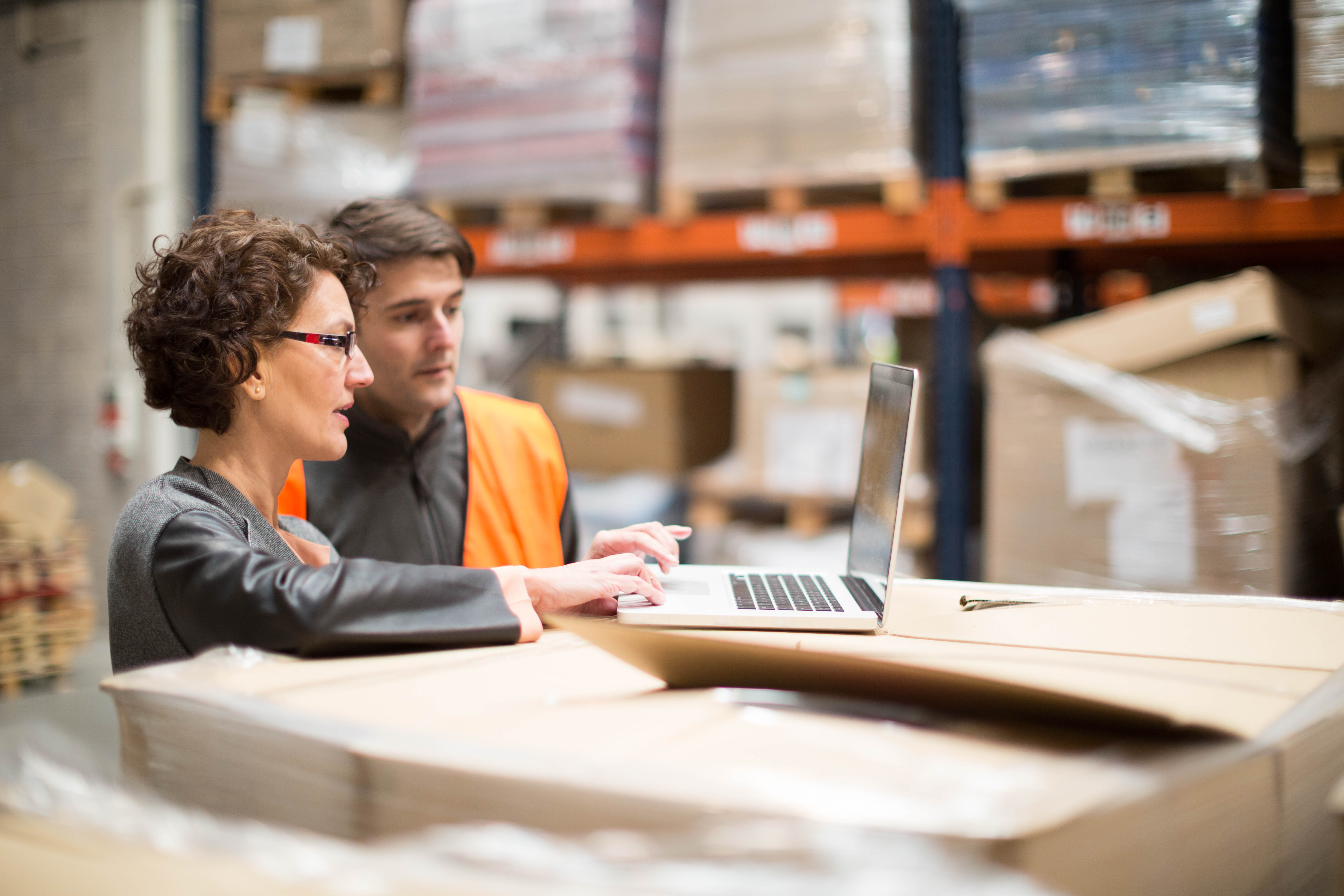 workers in warehouse on a computer