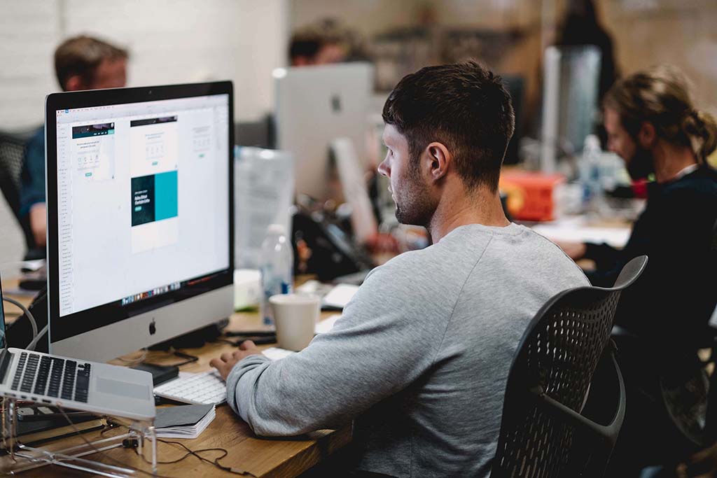 male student looking at computer screen