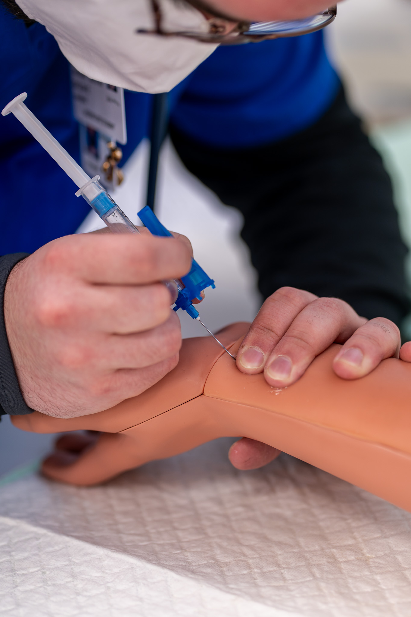 Student Learning to Draw Blood on fake arm