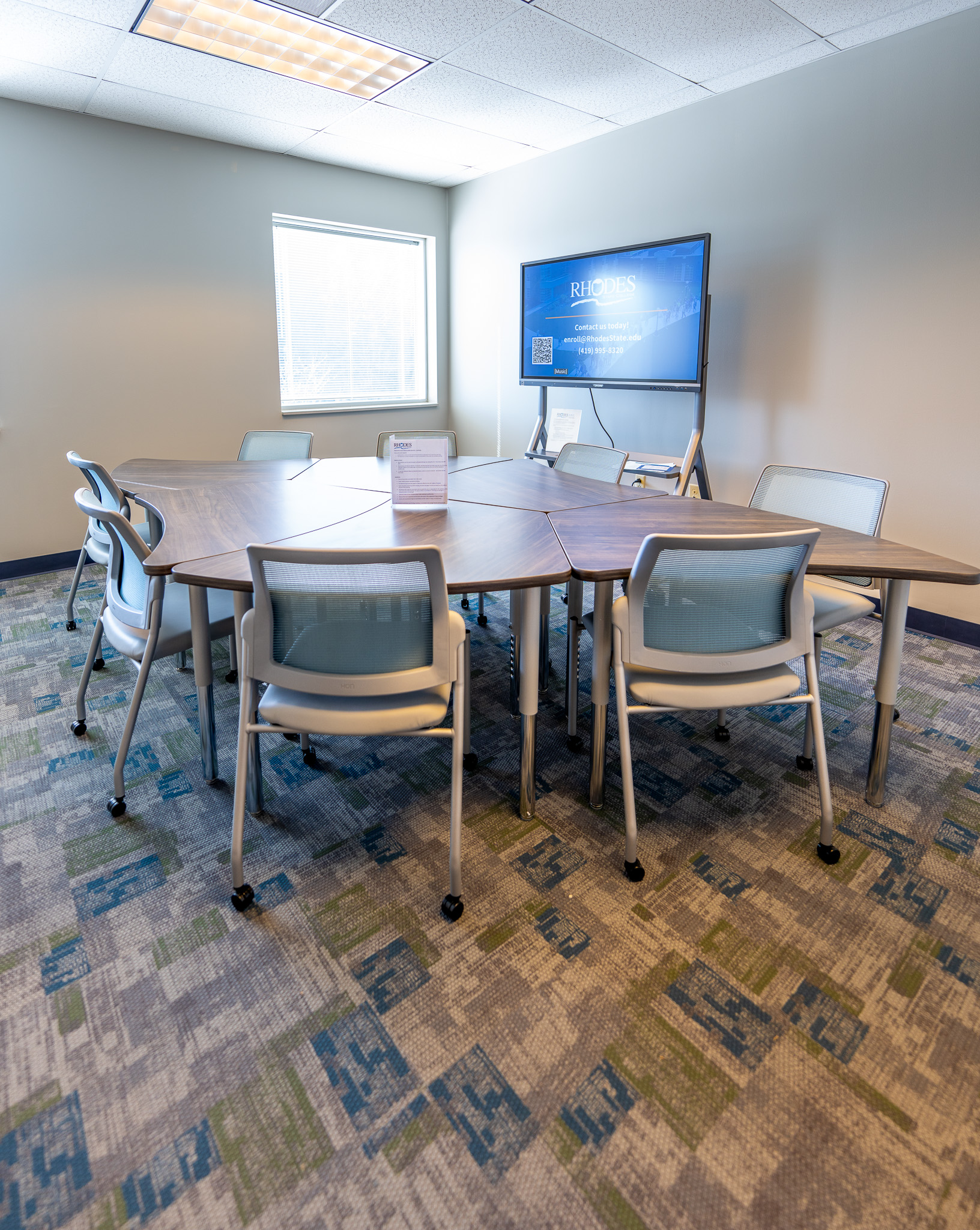 Bright room with moveable desks and chairs.