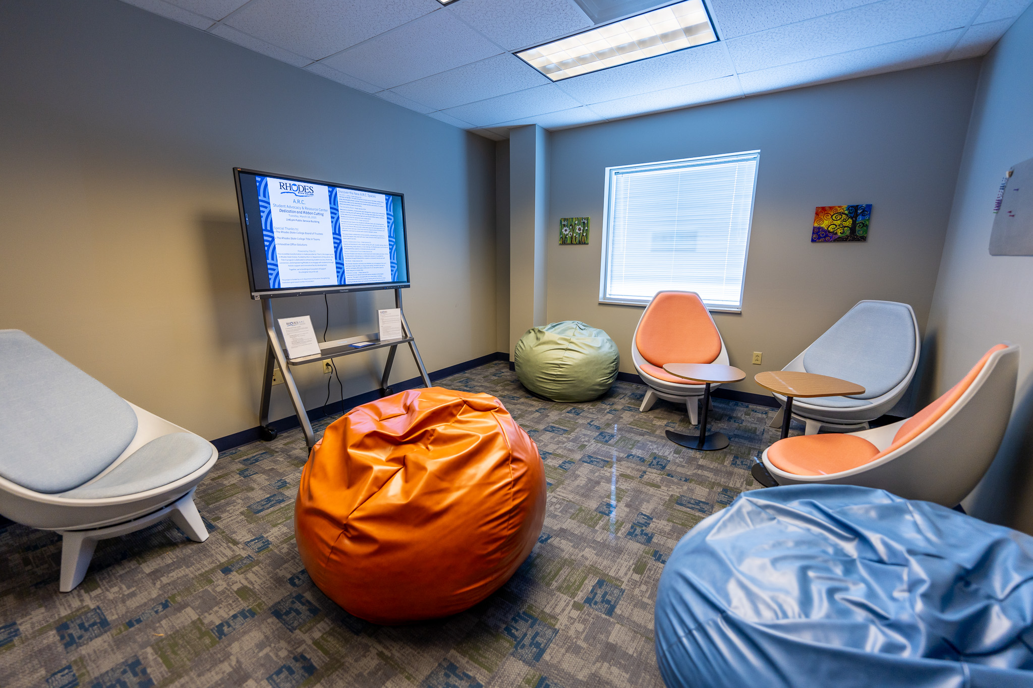 Comfy room with bean bags and egg chairs with desks.