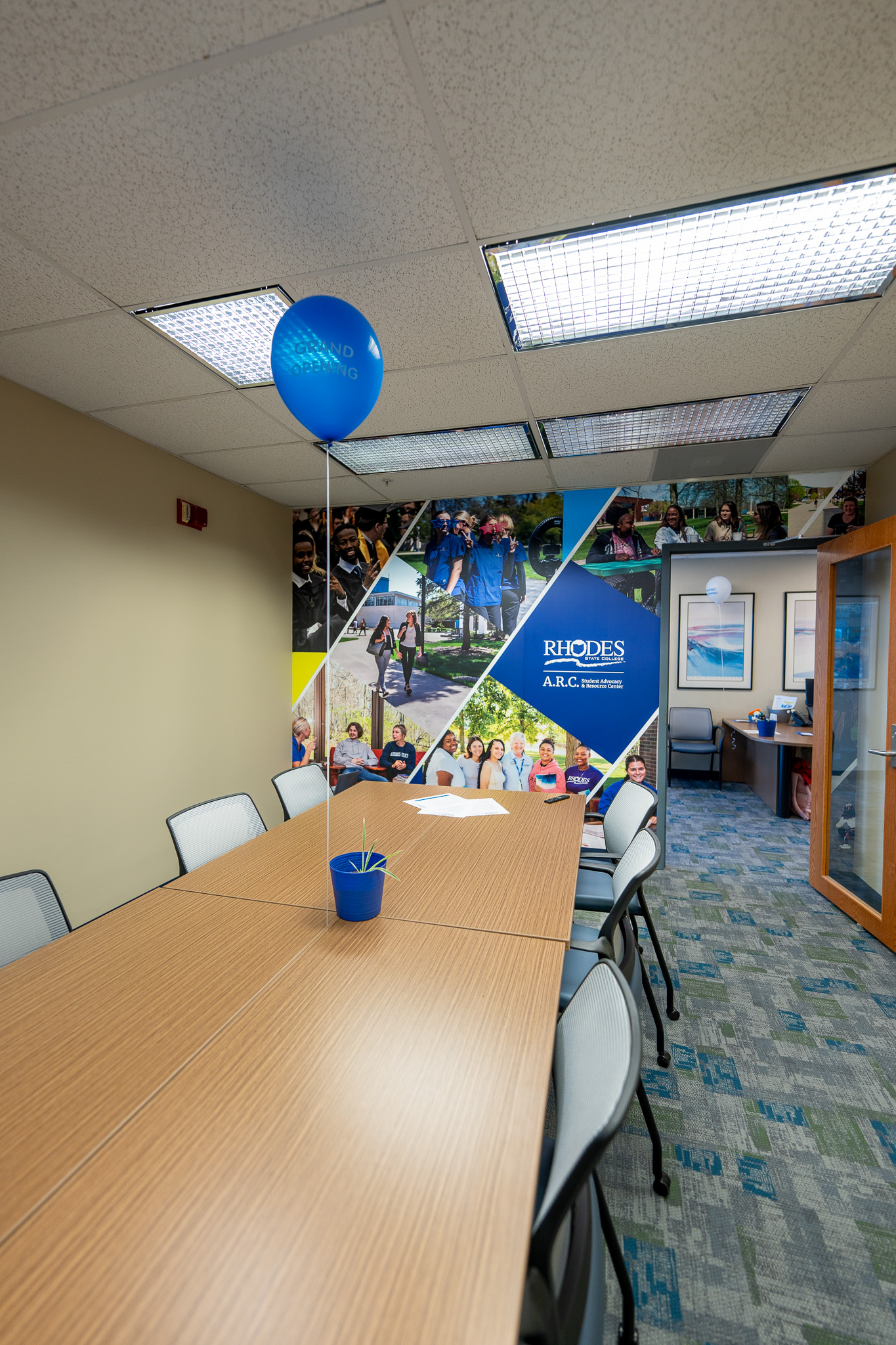Meeting Room with a long table and a mural on the wall.