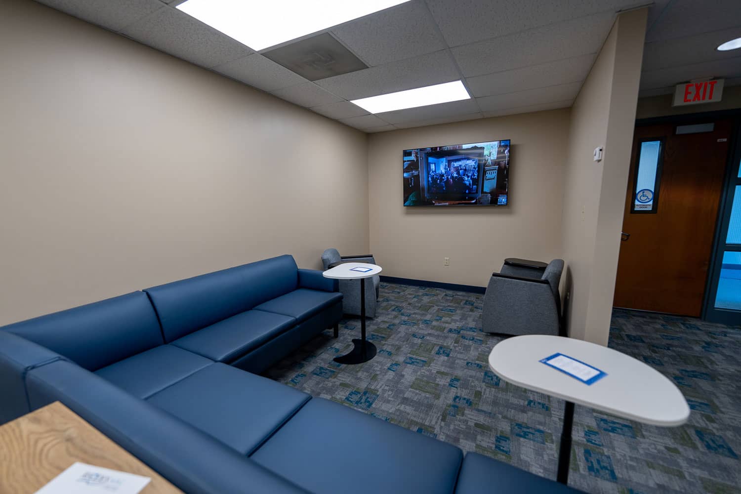 Comfy blue couch and tv.